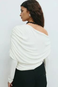 Sloped shoulder cape top